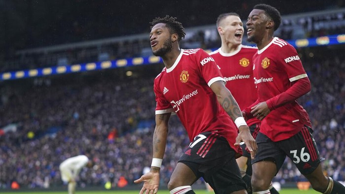 Manchester Uniteds Fred, left, celebrates after scoring his sides third goal during the English Premier League soccer match between Leeds United and Manchester United, at Elland Road Stadium in Leeds, England, Sunday, Feb. 20, 2022. (AP Photo/Jon Super)