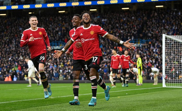 LEEDS, ENGLAND - FEBRUARY 20: Fred celebrates with Anthony Elanga and Scott McTominay of Manchester United after scoring their teams third goal during the Premier League match between Leeds United and Manchester United at Elland Road on February 20, 2022 in Leeds, England. (Photo by Shaun Botterill/Getty Images)