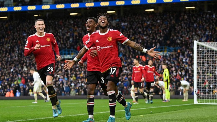LEEDS, ENGLAND - FEBRUARY 20: Fred celebrates with Anthony Elanga and Scott McTominay of Manchester United after scoring their teams third goal during the Premier League match between Leeds United and Manchester United at Elland Road on February 20, 2022 in Leeds, England. (Photo by Shaun Botterill/Getty Images)