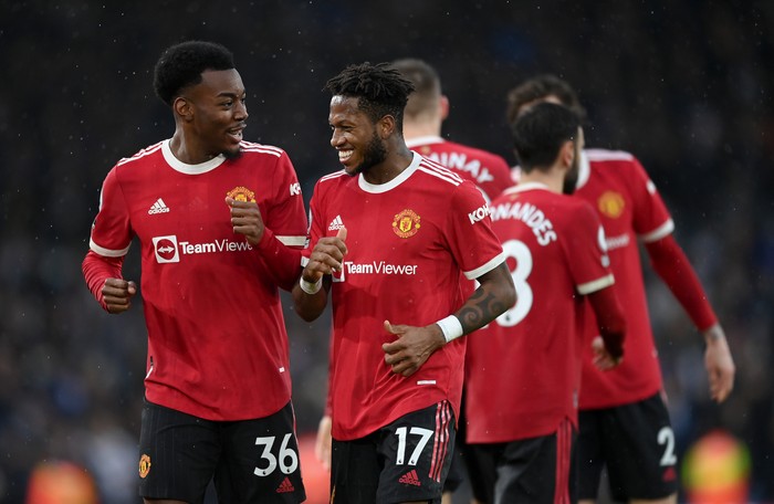 LEEDS, ENGLAND - FEBRUARY 20: Anthony Elanga of Manchester United celebrates with teammate Fred (R) after scoring their sides fourth goal during the Premier League match between Leeds United and Manchester United at Elland Road on February 20, 2022 in Leeds, England. (Photo by Shaun Botterill/Getty Images)