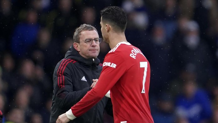 Manchester United's interim manager Ralf Rangnick, left, shakes hands with Manchester United's Cristiano Ronaldo during the English Premier League soccer match between Leeds United and Manchester United, at Elland Road Stadium in Leeds, England, Sunday, Feb. 20, 2022. (AP Photo/Jon Super)