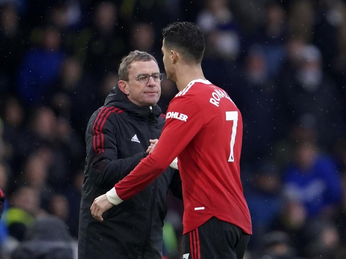 Manchester United's interim manager Ralf Rangnick, left, shakes hands with Manchester United's Cristiano Ronaldo during the English Premier League soccer match between Leeds United and Manchester United, at Elland Road Stadium in Leeds, England, Sunday, Feb. 20, 2022. (AP Photo/Jon Super)
