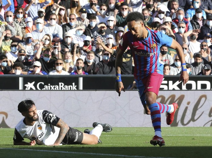 Pierre-Emerick Aubameyang Barcelona's Pierre-Emerick Aubameyang, right, reacts as he scores the opening goal during a Spanish La Liga soccer match between Valencia and Barcelona at the Mestalla stadium in Valencia, Spain, Sunday, Feb. 20, 2022. (AP Photo/Alberto Saiz)
