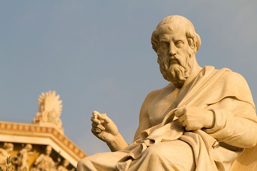Statue of Plato, Greek Philosopher. Pediment of the building of the Academy of Athens in the background, Athens, Greece.