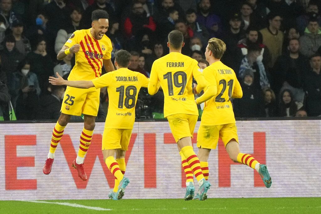 Barcelona's Pierre-Emerick Aubameyang, left, celebrates with teammates after scoring during the Europa League Soccer match between Napoli and Barcelona at the San Paolo stadium in Naples, Italy, Thursday, Feb. 24, 2022. (AP Photo/Gregorio Borgia)
