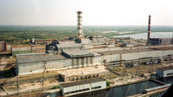 FILE - In this July 23, 1998 file photo, a chimney towers over the sarcophagus that covers the destroyed Reactor No.4 at the Chernobyl nuclear power plant. Twenty-five years ago, the Chernobyl Nuclear Power Plant exploded in Ukraine, spreading radioactive material across much of the northern hemisphere.  The April 26, 1986 explosion at the Chernobyl nuclear power plant affected about 3.3 million Ukrainians, including 1.5 million children, according to Ukraines Chernobyl Union report. The plant was closed for good in 2000. (AP Photo/Efrem Lukatsky, File)