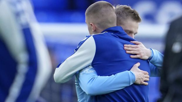 Manchester City's Oleksandr Zinchenko of Ukraine, left, hugs Everton's Vitaliy Mykolenko of Ukraine before the English Premier League soccer match between Everton and Manchester City at Goodison Park in Liverpool, England, Saturday, Feb. 26, 2022. (AP Photo/Jon Super)