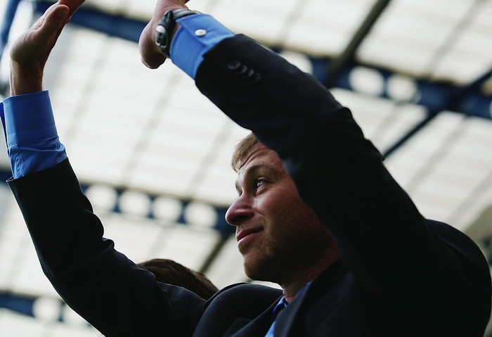 Roman Abramovich LONDON - MAY 14: Chelsea owner, Roman Abramovich shows the Premiership Trophy to the fans on the open-topped bus parade of the Barclays Premiership trophy and the FA Community Shield as they make their way down New King's Road on the Chelsea Football Club victory parade on May 14, 2006 in London, England. Chelsea became only the second club to win back to back Premiership Titles gaining manager Jose Mourinho his second title in two years. (Photo by Dean Mouhtaropoulos/Getty Images)