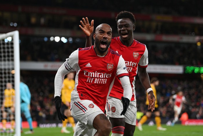 LONDON, ENGLAND - FEBRUARY 24: Alexandre Lacazette of Arsenal celebrates their sides second goal with team mate Bukayo Saka during the Premier League match between Arsenal and Wolverhampton Wanderers at Emirates Stadium on February 24, 2022 in London, England. (Photo by Shaun Botterill/Getty Images)