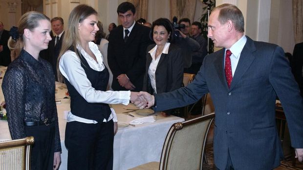 Alina Kabayeva Russian President Vladimir Putin (R) shakes hands with famous Russian gymnasts Alina Kabayeva (C) and Svetlana Khorkina (L) during the meeting with sportsmen, candidates to Russian Olympic team for Olympics 2004, in the presidential residence in Novo-Ogaryovo outside Moscow, 10 March 2004. Vladimir Putin said Russian business is ready to support Russian sportsmen. AFP PHOTO / POOL (Photo by SERGEI CHIRIKOV / POOL / AFP)