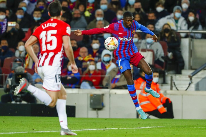 Barcelonas Ousmane Dembele controls the ball as Athletic Bilbaos Inigo Lekue looks on during a Spanish La Liga soccer match at the Camp Nou stadium in Barcelona, Spain, Sunday, Feb. 27, 2022. (AP Photo/Joan Monfort)