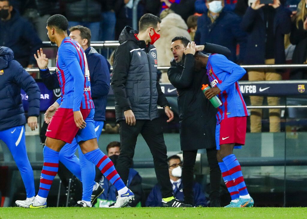 Barcelona's Ousmane Dembele controls the ball as Athletic Bilbao's Inigo Lekue looks on during a Spanish La Liga soccer match at the Camp Nou stadium in Barcelona, Spain, Sunday, Feb. 27, 2022. (AP Photo/Joan Monfort)