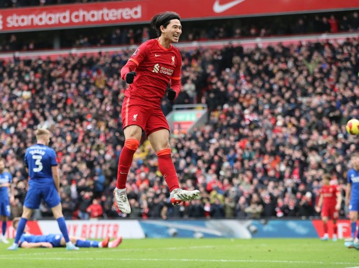 LIVERPOOL, ENGLAND - FEBRUARY 06: Liverpool player Takumi Minamino celebrates after scoring the second Liverpool goal during the Emirates FA Cup Fourth Round match between Liverpool and Cardiff City at Anfield on February 06, 2022 in Liverpool, England. (Photo by Clive Brunskill/Getty Images)