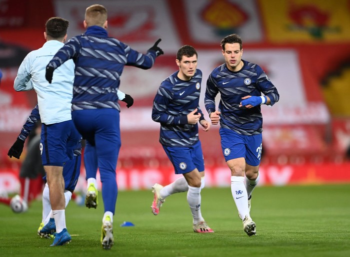 LIVERPOOL, ENGLAND - MARCH 04: Cesar Azpilicueta of Chelsea warms up with Andreas Christensen and team mates prior to the Premier League match between Liverpool and Chelsea at Anfield on March 04, 2021 in Liverpool, England. Sporting stadiums around the UK remain under strict restrictions due to the Coronavirus Pandemic as Government social distancing laws prohibit fans inside venues resulting in games being played behind closed doors. (Photo by Laurence Griffiths/Getty Images)