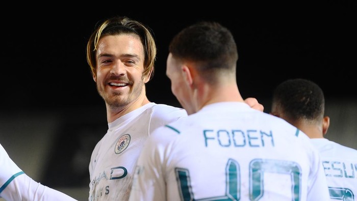 PETERBOROUGH, ENGLAND - MARCH 01: Jack Grealish of Manchester City celebrates after scoring their teams second goal during the Emirates FA Cup Fifth Round match between Peterborough United and Manchester City at ABAX Stadium on March 01, 2022 in Peterborough, England. (Photo by Laurence Griffiths/Getty Images)