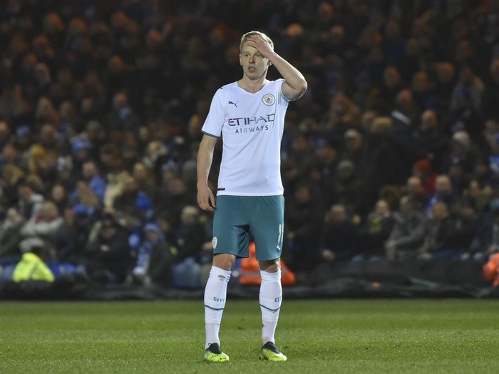 Manchester Citys Oleksandr Zinchenko stands on the pitch during the English FA Cup fifth round soccer match between Peterborough United and Manchester City at the Weston Homes Stadium, Peterborough, England, Tuesday, March 1, 2022. (AP Photo/Rui Vieira)