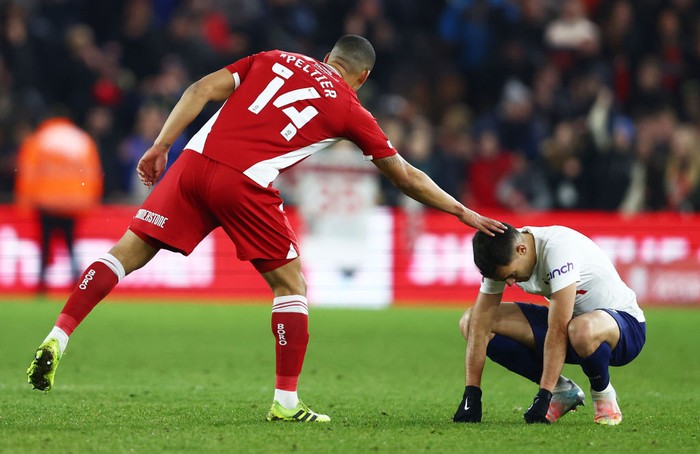 MIDDLESBROUGH, ENGLAND - MARCH 01: Sergio Reguilon of Tottenham Hotspur is embraced by Lee Peltier of Middlesbrough after the Emirates FA Cup Fifth Round match between Middlesbrough and Tottenham Hotspur at Riverside Stadium on March 01, 2022 in Middlesbrough, England. (Photo by Clive Brunskill/Getty Images)