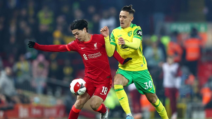 LIVERPOOL, ENGLAND - MARCH 02: Takumi Minamino of Liverpool battles for possession with Dimitris Giannoulis of Norwich City  during the Emirates FA Cup Fifth Round match between Liverpool and Norwich City at Anfield on March 02, 2022 in Liverpool, England. (Photo by Clive Brunskill/Getty Images)