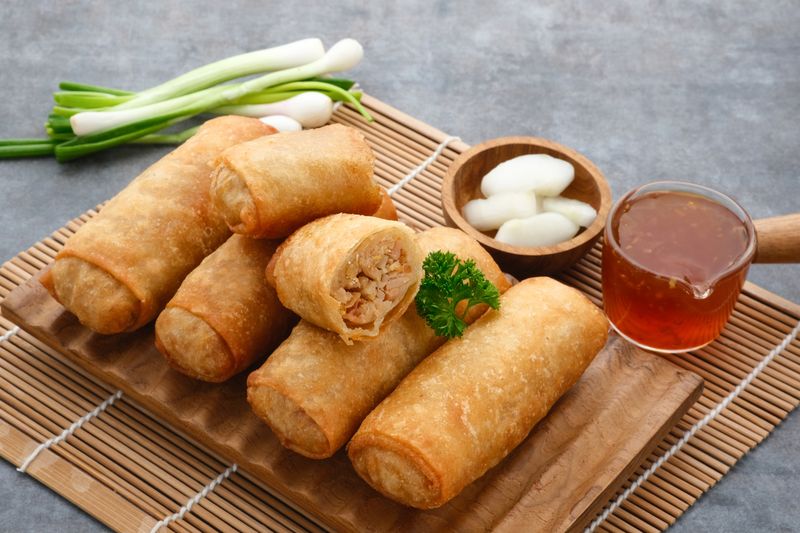 Lumpia or lunpia, a traditional snack from Semarang, Central Java, Indonesia. Traditional Spring rolls food containing sauted bamboo(rebung), eggs, and chicken or shrimp. Selective focus image.