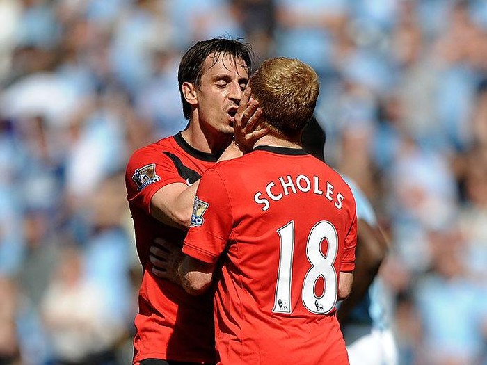 MANCHESTER, ENGLAND - APRIL 17:  Paul Scholes of Manchester United is kissed by team mate Gary Neville after scoring the winning goal during the Barclays Premier League match between Manchester City and Manchester United at the City of Manchester Stadium on April 17, 2010 in Manchester, England.  (Photo by Laurence Griffiths/Getty Images)