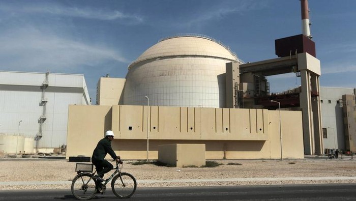 FILE - In this Oct. 26, 2010 file photo, a worker rides a bicycle in front of the reactor building of the Bushehr nuclear power plant, just outside the southern city of Bushehr. Iranâs sole nuclear power plant has undergone a temporary emergency shutdown, state TV reported on Sunday, June 20, 2021. An official from the state electric energy company, Gholamali Rakhshanimehr, said on a talk show that the Bushehr plant shutdown began on Saturday and would last 
