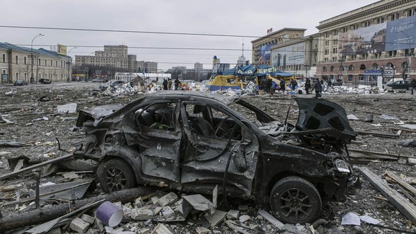 A damaged car sits at the central square following shelling of the City Hall building in Kharkiv, Ukraine, Tuesday, March 1, 2022.(AP Photo/Pavel Dorogoy)