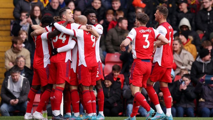 WATFORD, ENGLAND - MARCH 06: Martin Odegaard of Arsenal (obscured) celebrates with team mates after scoring their sides first goal during the Premier League match between Watford and Arsenal at Vicarage Road on March 06, 2022 in Watford, England. (Photo by Alex Pantling/Getty Images)