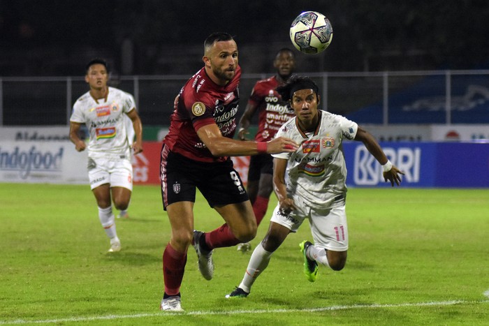 Pesepak bola Bali United Ilija Spasojevic (tengah) berusaha melewati hadangan pesepak bola Persija Jakarta Novri (kanan) pada pertandingan Liga 1 di Stadion I Gusti Ngurah Rai, Denpasar, Bali, Minggu (6/3/2022) malam. ANTARA FOTO/Nyoman Hendra Wibowo/nym.