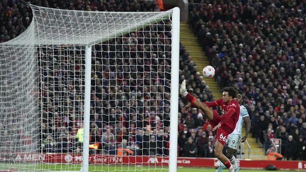 Liverpool's Trent Alexander-Arnold kicks the ball to save a goal during the English Premier League soccer match between Liverpool and West Ham United at Anfield stadium in Liverpool, England, Saturday, March 5, 2022. (AP Photo/Jon Super)