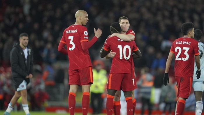 Liverpools Sadio Mane, center back to camera, hugs a teammate to celebrate their win in the English Premier League soccer match against West Ham United at Anfield stadium in Liverpool, England, Saturday, March 5, 2022. (AP Photo/Jon Super)