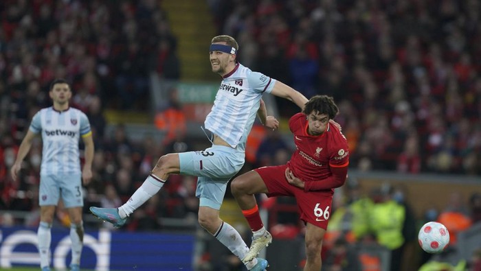West Hams Tomas Soucek, center, and Liverpools Trent Alexander-Arnold fight for the ball during the English Premier League soccer match between Liverpool and West Ham United at Anfield stadium in Liverpool, England, Saturday, March 5, 2022. (AP Photo/Jon Super)