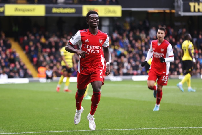 WATFORD, ENGLAND - MARCH 06: Bukayo Saka of Arsenal celebrates after scoring their sides second goal during the Premier League match between Watford and Arsenal at Vicarage Road on March 06, 2022 in Watford, England. (Photo by Alex Pantling/Getty Images)