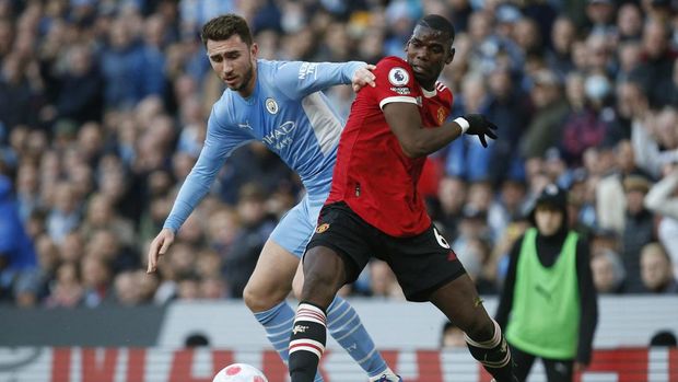 Soccer Football - Premier League - Manchester City v Manchester United - Etihad Stadium, Manchester, Britain - March 6, 2022 Manchester City's Aymeric Laporte in action with Manchester United's Paul Pogba REUTERS/Craig Brough EDITORIAL USE ONLY. No use with unauthorized audio, video, data, fixture lists, club/league logos or 'live' services. Online in-match use limited to 75 images, no video emulation. No use in betting, games or single club /league/player publications.  Please contact your account representative for further details.