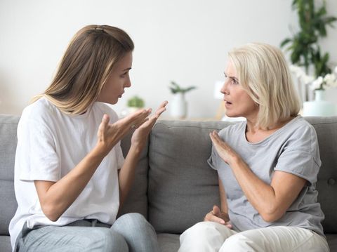 Angry young woman has disagreement with annoyed old mother in law, grown daughter arguing fighting quarreling with senior elderly mom, different age generations bad relations family conflict concept