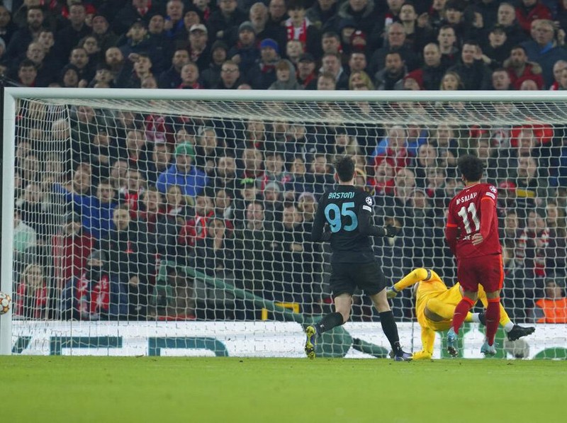 The ball hits a post after Liverpool's Mohamed Salah, right, shots on target during the Champions League, round of 16, second leg soccer match between Liverpool and Inter Milan at Anfield stadium in Liverpool, England, Tuesday, March 8, 2022. (AP Photo/Jon Super)