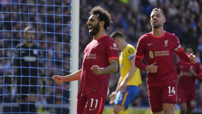 Liverpools Mohamed Salah celebrates after scoring his sides second goal on a penalty kick during the English Premier League soccer match between Brighton and Hove Albion and Liverpool at the Amex stadium in Brighton, England, Saturday, March 12, 2022. (AP Photo/Kirsty Wigglesworth)