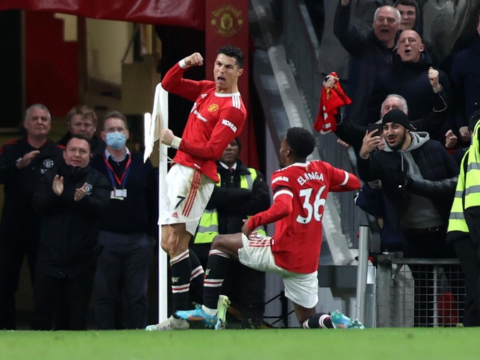 MANCHESTER, ENGLAND - MARCH 12: Cristiano Ronaldo of Manchester United celebrates after scoring their sides third goal during the Premier League match between Manchester United and Tottenham Hotspur at Old Trafford on March 12, 2022 in Manchester, England. (Photo by Naomi Baker/Getty Images)