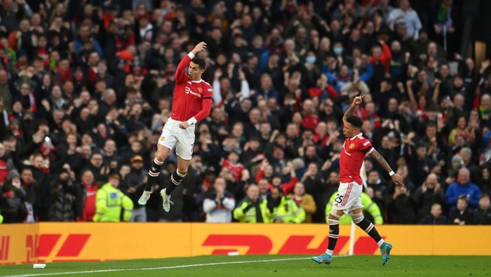 MANCHESTER, ENGLAND - MARCH 12: Cristiano Ronaldo of Manchester United celebrates after scoring their sides first goal during the Premier League match between Manchester United and Tottenham Hotspur at Old Trafford on March 12, 2022 in Manchester, England. (Photo by Michael Regan/Getty Images)