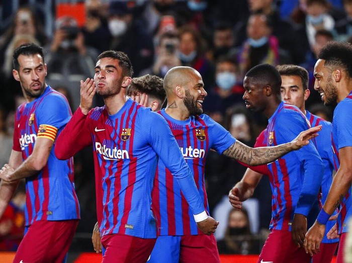 FC Barcelona's players celebrate a goal during a Spanish La Liga soccer match between FC Barcelona and Osasuna at the Camp Nou stadium in Barcelona, Spain, Sunday, March 13, 2022. (AP Photo/Joan Monfort)