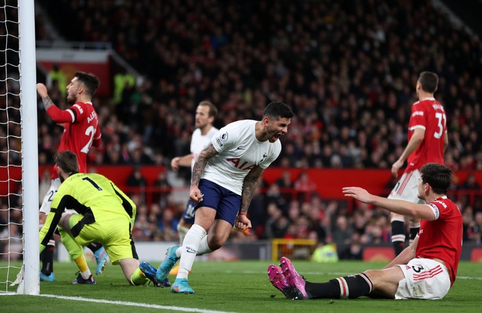 MANCHESTER, ENGLAND - MARCH 12: Cristian Romero of Tottenham Hotspur celebrates in front of Harry Maguire of Manchester United after he scores an own goal during the Premier League match between Manchester United and Tottenham Hotspur at Old Trafford on March 12, 2022 in Manchester, England. (Photo by Naomi Baker/Getty Images)