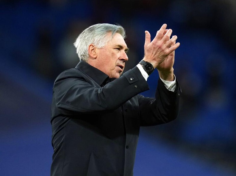 Real Madrid's head coach Carlo Ancelotti, right, and Ferland Mendy celebrate after the Spanish La Liga soccer match between Real Madrid and Real Sociedad at the Bernabeu stadium in Madrid, Spain, Saturday, March 5, 2022. Real Madrid won the match 4-1. (AP Photo/Manu Fernandez)
