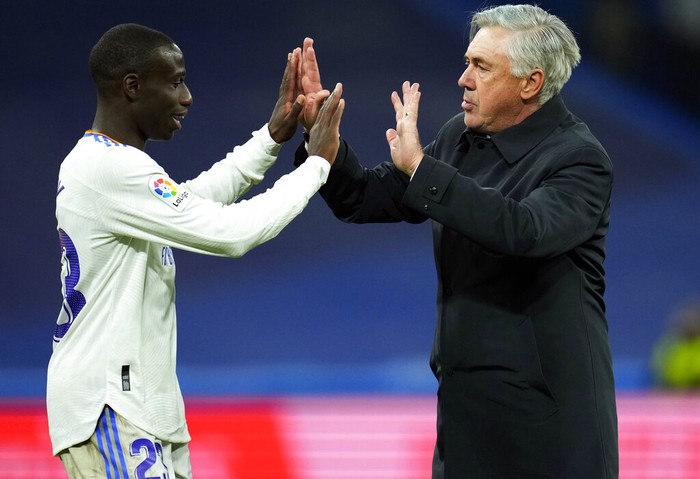 Real Madrid's head coach Carlo Ancelotti, right, and Ferland Mendy celebrate after the Spanish La Liga soccer match between Real Madrid and Real Sociedad at the Bernabeu stadium in Madrid, Spain, Saturday, March 5, 2022. Real Madrid won the match 4-1. (AP Photo/Manu Fernandez)