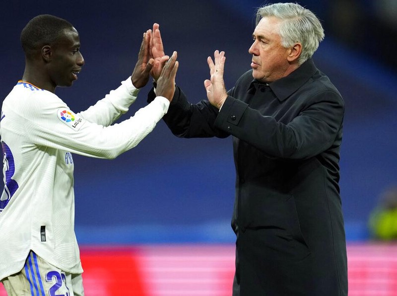 Real Madrid's head coach Carlo Ancelotti, right, and Ferland Mendy celebrate after the Spanish La Liga soccer match between Real Madrid and Real Sociedad at the Bernabeu stadium in Madrid, Spain, Saturday, March 5, 2022. Real Madrid won the match 4-1. (AP Photo/Manu Fernandez)