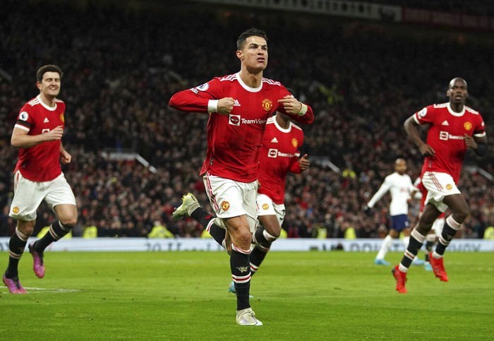 Manchester Uniteds Cristiano Ronaldo, center, celebrates after scoring his third goal during the English Premier League soccer match between Manchester United and Tottenham Hotspur, at the Old Trafford stadium in Manchester, England, Saturday, March 12, 2022. (Martin Rickett/PA via AP)