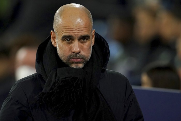 Manchester Citys head coach Pep Guardiola looks on before the Champions League round of 16 second leg soccer match between Manchester City and Sporting Lisbon at the City of Manchester Stadium in Manchester, England, Wednesday, March 9, 2022. (AP Photo/Dave Thompson)