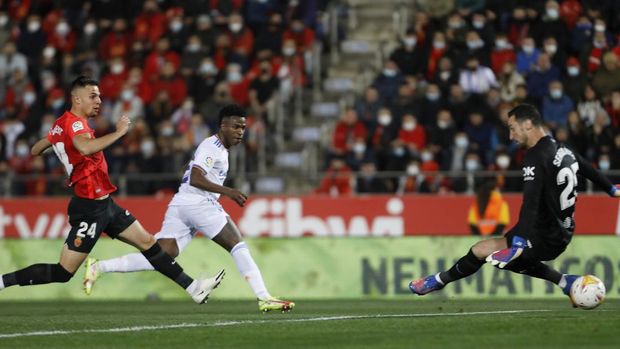 Real Madrid's Vinicius Junior, centre, scores the opening goal during a Spanish La Liga soccer match between Mallorca and Real Madrid in Palma de Mallorca, Spain, Monday, March 14, 2022. (AP Photo/Francisco Ubilla)