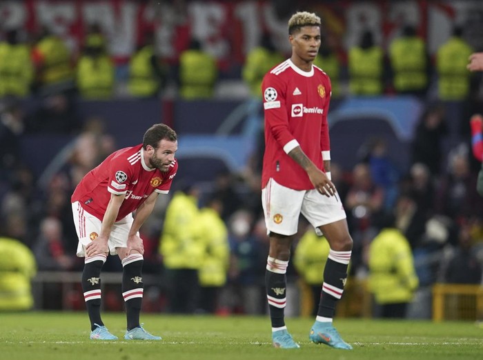 Manchester Uniteds Juan Mata, left, and teammate Marcus Rashford react following the Champions League round of 16, second leg soccer match between Manchester United and Atletico Madrid at Old Trafford, Manchester, England, Tuesday, March 15, 2022. (AP Photo/Dave Thompson)