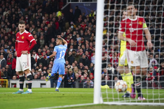 Atletico Madrid's Renan Lodi celebrates after scoring his team's first goal during the Champions League round of 16, second leg soccer match between Manchester United and Atletico Madrid at Old Trafford, Manchester, England, Tuesday, March 15, 2022. (AP Photo/Dave Thompson)