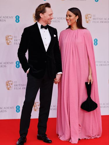 British actor Tom Hiddleston (L) and British actress Zawe Ashton pose on the red carpet upon arrival at the BAFTA British Academy Film Awards at the Royal Albert Hall, in London, on March 13, 2022. (Photo by Tolga Akmen / AFP)