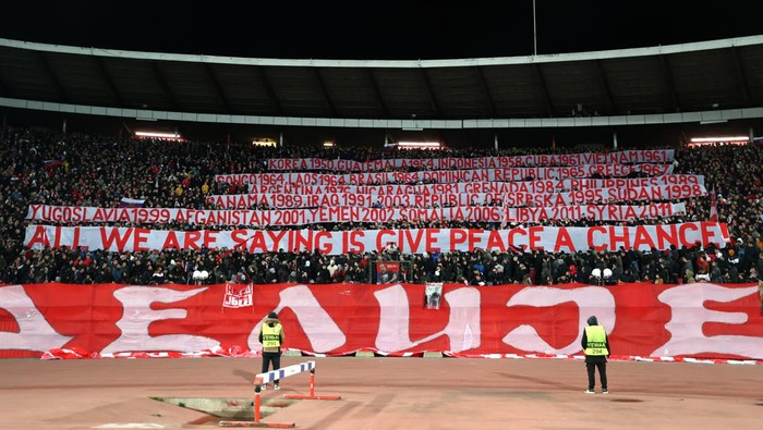 BELGRADE, SERBIA - MARCH 17: Cvena Zvezda fans hold banners to indicate peace and sympathy with Ukraine during the UEFA Europa League Round of 16 Leg Two match between Crvena Zvezda and Rangers FC at Rajko Mitic Stadium on March 17, 2022 in Belgrade, Serbia. (Photo by Alex Pantling/Getty Images)